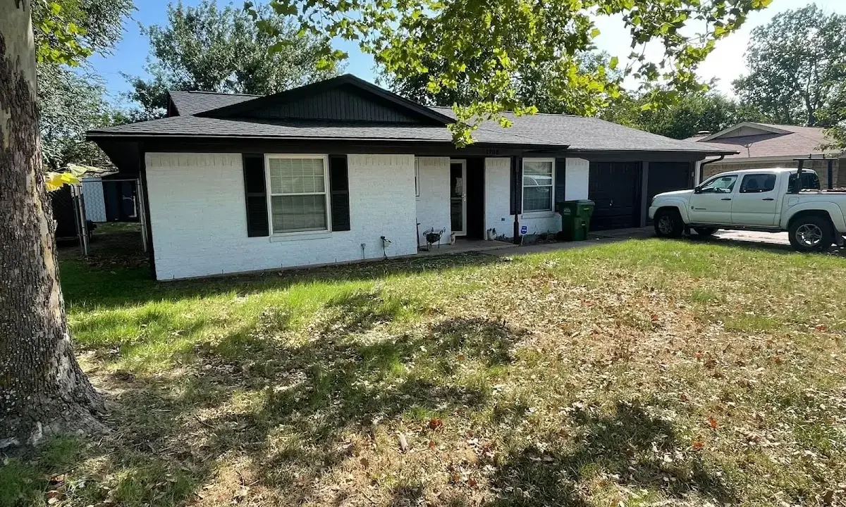 Professional roofing crew working on a residential roof in White Center